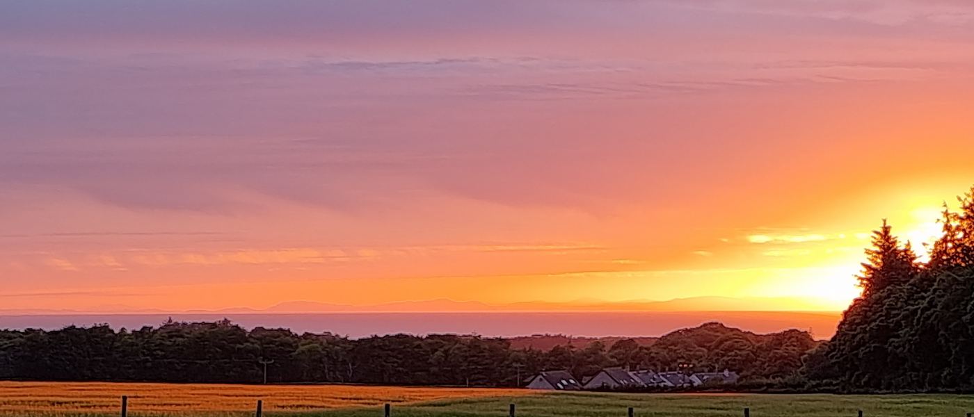 A vivid sunset over the fields at Greencraig, photographed from the pitches
