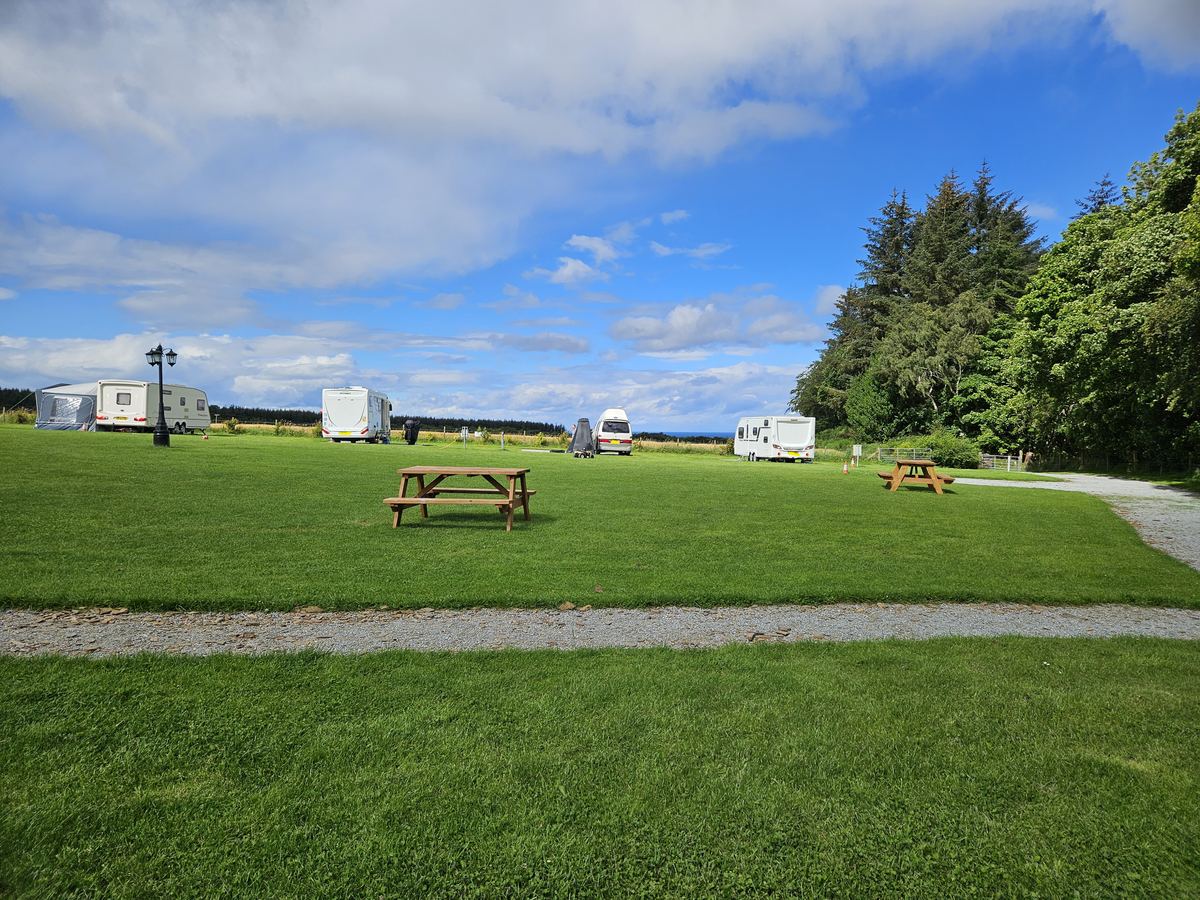 Level gravel and grass caravan pitches at Greencraig